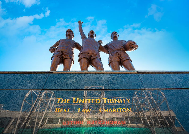 the united trilogy statues at old trafford best law and charlton